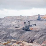 Aerial view of bucket-wheel excavators in an expansive open-pit coal mine.