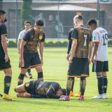 Soccer players gather around injured teammate during a match in Texcoco, Mexico.