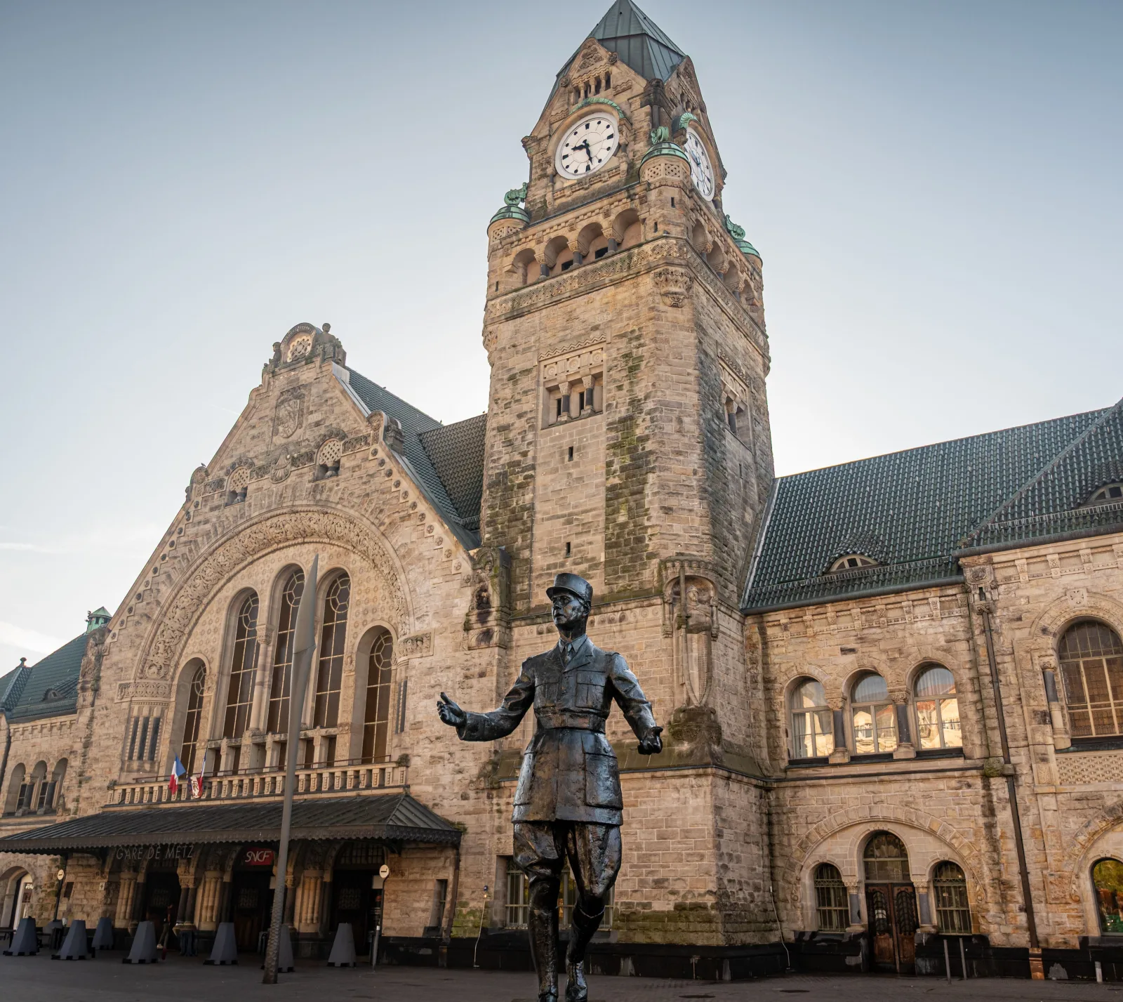 Metz-Ville Station in France with a prominent De Gaulle statue and historic architecture.