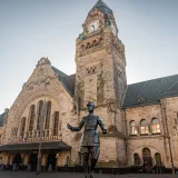 Metz-Ville Station in France with a prominent De Gaulle statue and historic architecture.