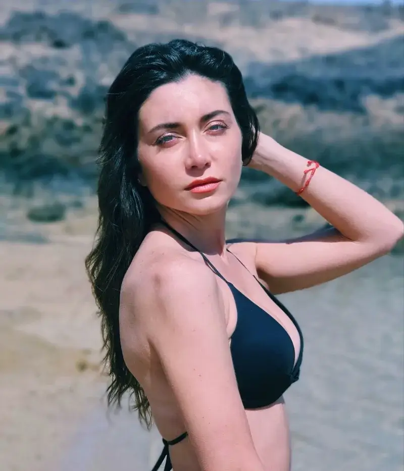 Captivating beach portrait of a woman in Playa Blanca, Spain, exuding summertime warmth and style.