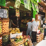 Bustling street market in Buenos Aires featuring colorful fruits and vegetables.