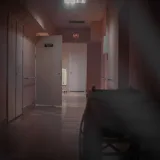 A deserted hospital corridor with open doors and dim lighting, enhancing a mysterious ambiance.
