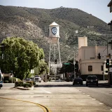 View of the historic Warner Bros water tower set against Los Angeles street backdrop.