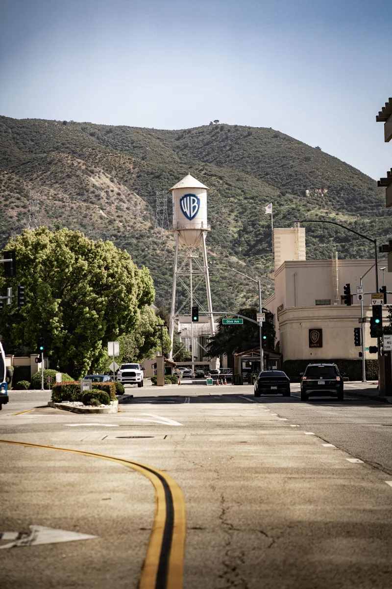 View of the historic Warner Bros water tower set against Los Angeles street backdrop.