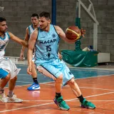 Dynamic shot of basketball players in action during an indoor game.