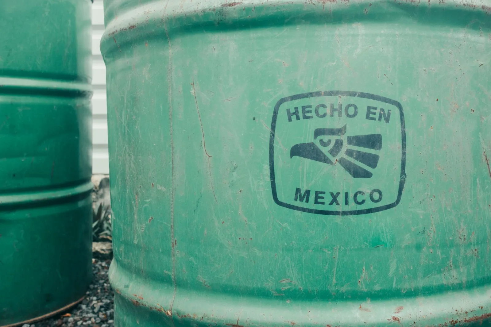Close-up of a green industrial barrel with 'Hecho en Mexico' text. Ideal for manufacturing themes.