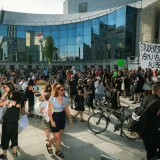 A large peaceful student protest in front of a modern building in Bratislava, Slovakia.