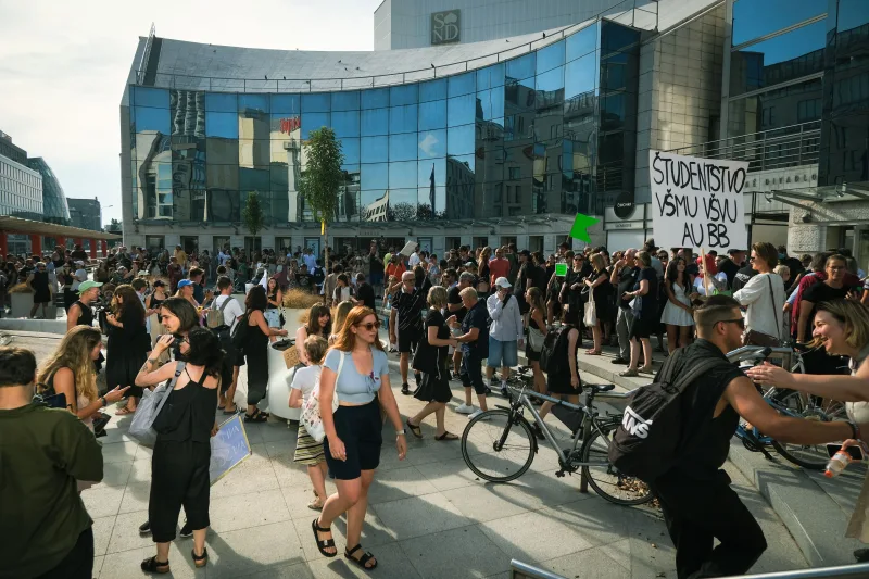 A large peaceful student protest in front of a modern building in Bratislava, Slovakia.