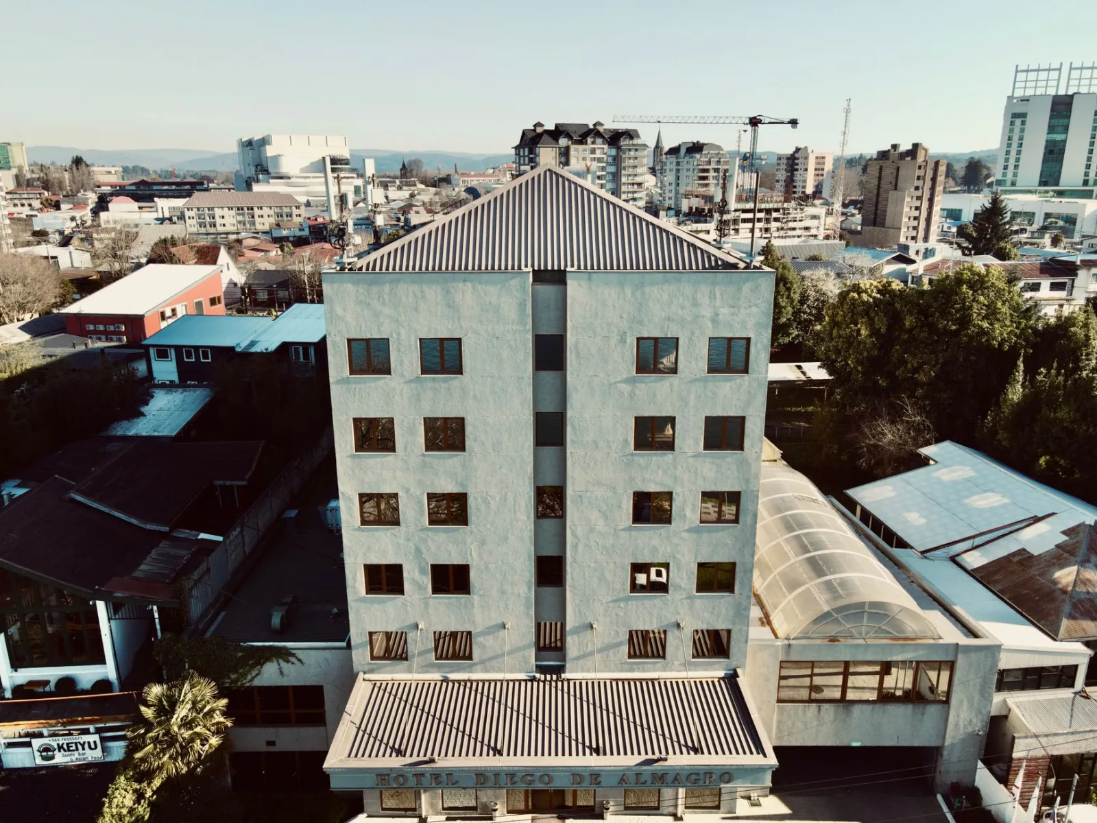 Aerial shot of Hotel Diego de Almagro in the cityscape of Valdivia, Chile, during daytime.