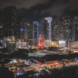 Vibrant Miami downtown skyline at night with illuminated skyscrapers and busy city vibes.