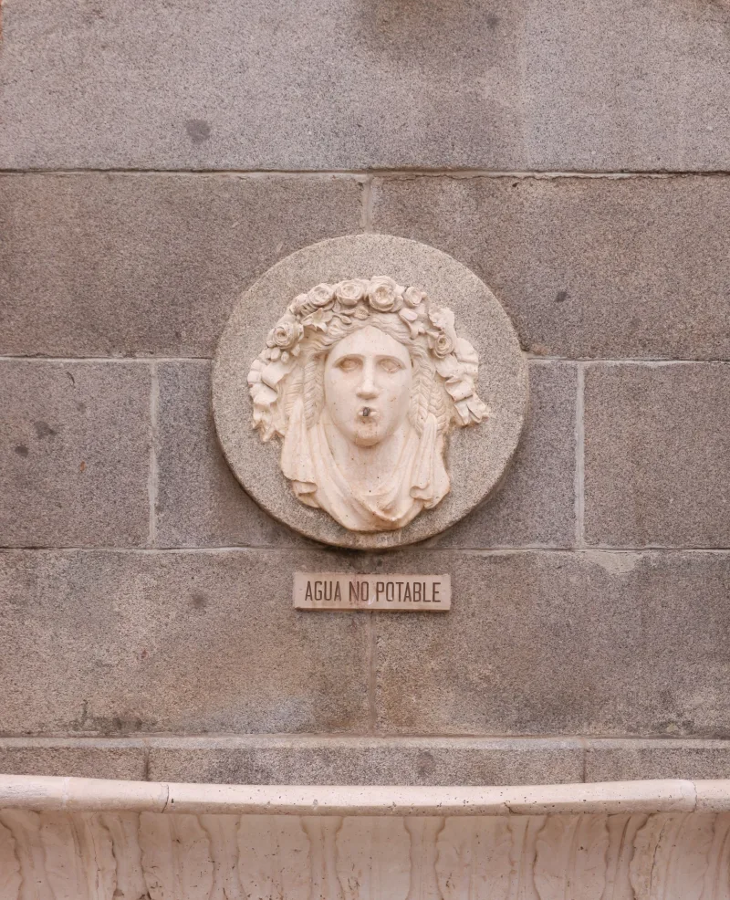 Sculpture with 'Agua No Potable' sign in Madrid, Spain.
