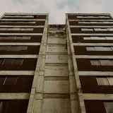 Low angle view of building exterior showcasing windows and sky in Mérida, Venezuela.