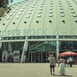 People entering Super Bock Arena in Porto, Portugal on a sunny day.