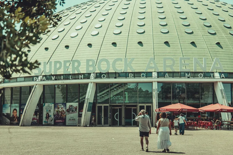People entering Super Bock Arena in Porto, Portugal on a sunny day.