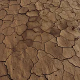 Dry cracked earth in Pica, Tarapacá, Chile, showcasing drought effects.