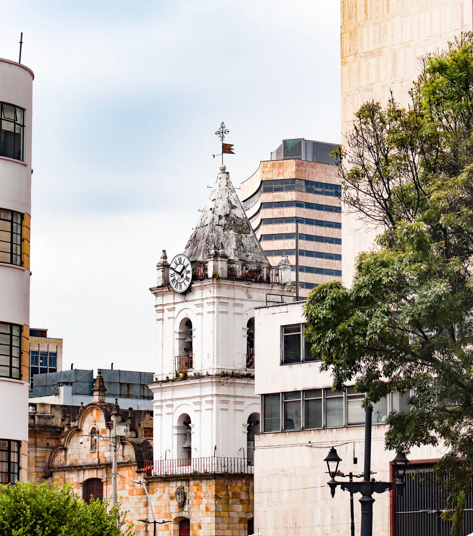 A scenic view of the historic clock tower and modern buildings in Bogotá, Colombia.