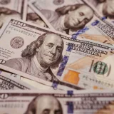 Pile of 100 dollar bills depicting wealth and financial success in close-up view.