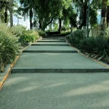 Peaceful garden pathway surrounded by vibrant plants and trees, perfect for relaxation.