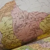 Detailed vintage map showing geographic regions in an old atlas book, highlighting Mérida, Venezuela.