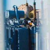 Power transformer setup in an industrial area of Samarkand, Uzbekistan, during daytime in autumn.