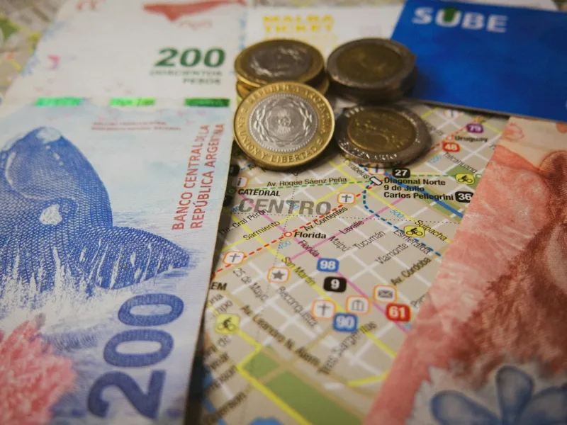 Buenos Aires' map with coins, bus ticket and some pesos notes