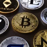 Detailed view of assorted cryptocurrency coins including Bitcoin, Ethereum, and Ripple.