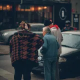 People gather on a city sidewalk in Adrogué, Buenos Aires, Argentina.