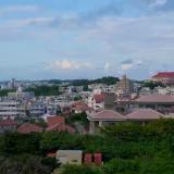 Panoramic view of Okinawa cityscape with traditional and modern buildings.