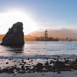 Stunning view of Rio de Janeiro's coastal landscape with oil platform at sunset.