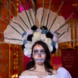 Portrait of a woman in colorful Catrina makeup and costume celebrating Dia de los Muertos in Toluca, Mexico.