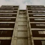 Low angle view of building exterior showcasing windows and sky in Mérida, Venezuela.