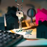 Real estate market finance calculator. Home heys on banknotes documents agreement.