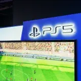 PS5 gaming station featuring a live soccer match onscreen, showcasing high-quality graphics.