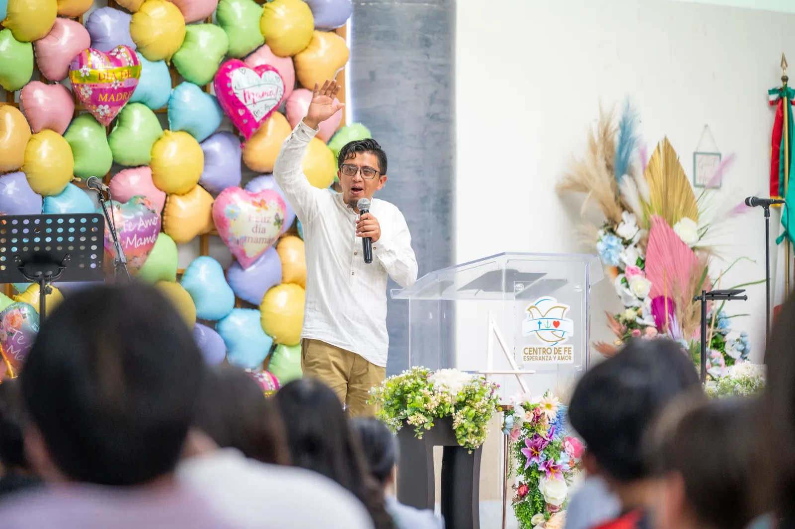 A pastor speaks passionately during a vibrant church event in Ciudad de México, Mexico.