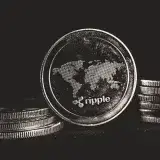 A detailed shot of a Ripple coin with a world map design on a black background.