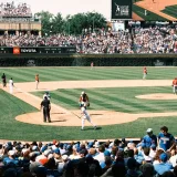 Vibrant scene of a baseball game at Wrigley Field with packed grandstands and players in action.
