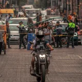 Motorcyclist navigating busy urban traffic in Ciudad de México, showcasing vibrant street life.