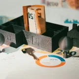 Real estate finance. House model table money banknotes. Door key.