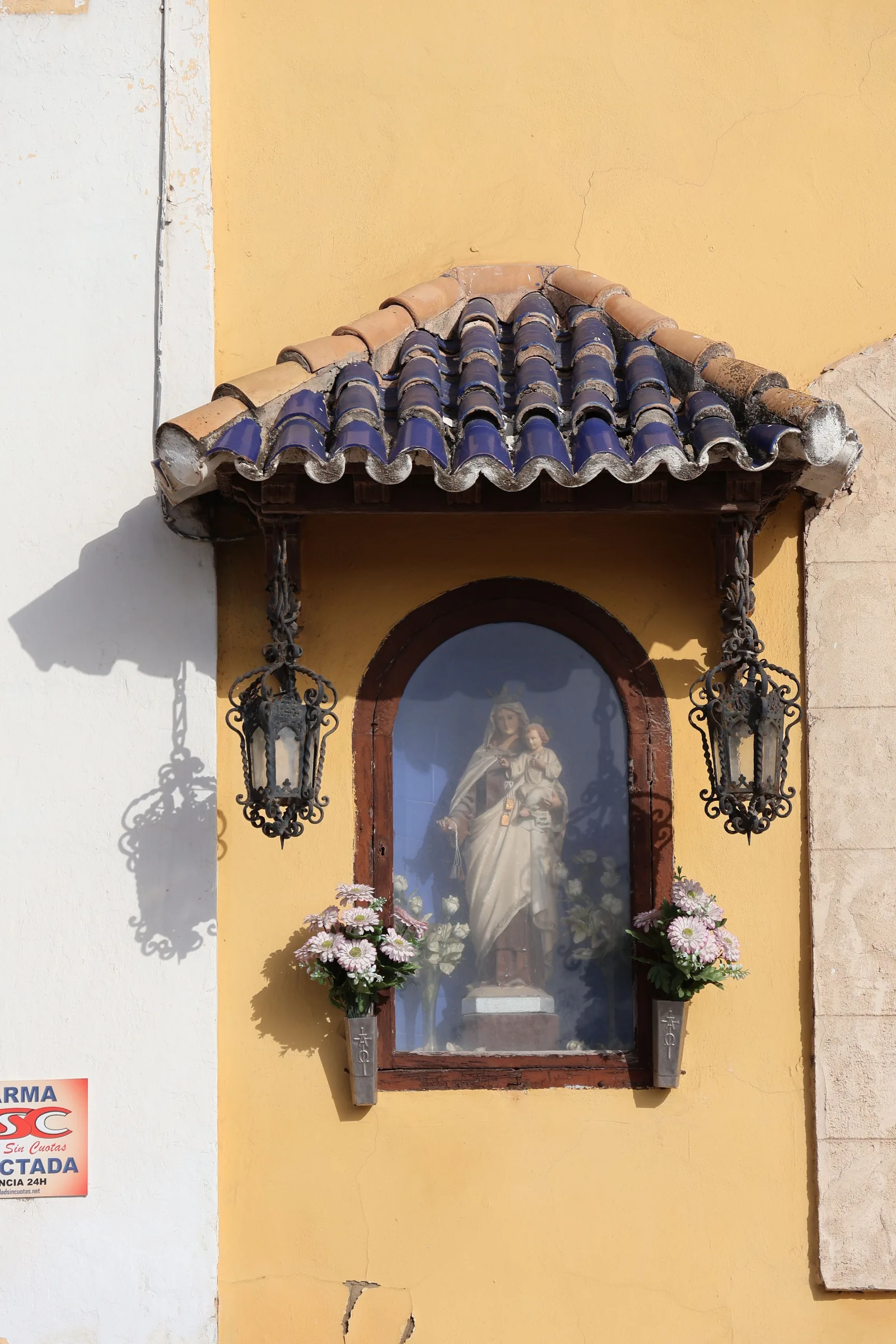 This image shows the Virgen del Carmen statue in El Puerto de Santa María, framed by traditional Spanish architecture.