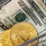 Gold bitcoins and US dollar bills in a small shopping cart representing finance and digital currency.
