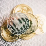 Close-up of Litecoin and Bitcoin coins on a textured surface, representing digital currency themes.