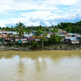 Aerial view of the rural riverside town of Puerto Nuevo, Chocó, Colombia.