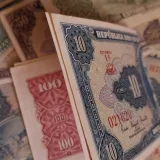 Assorted vintage currency notes from different countries showcasing rich history and design.