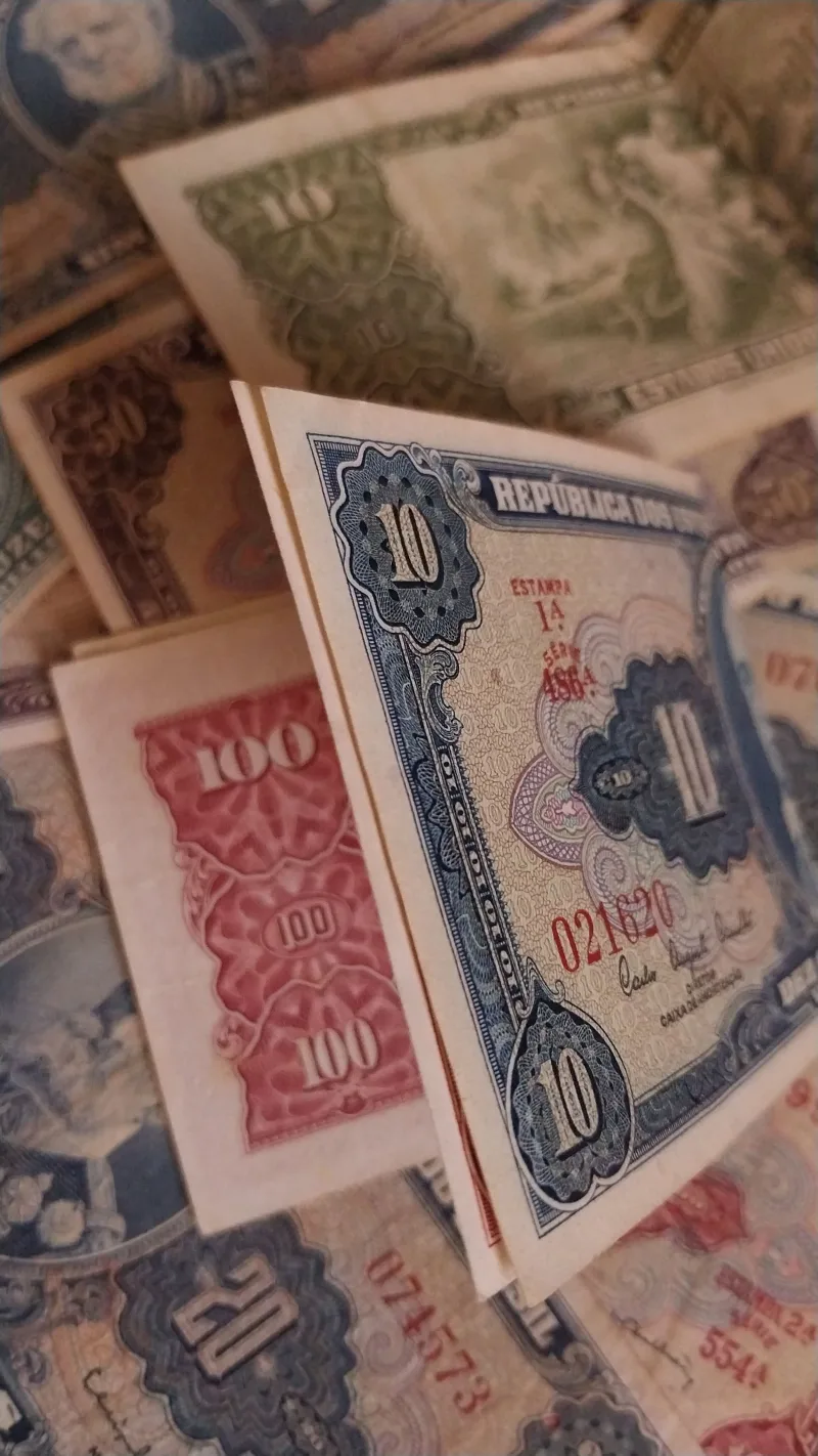 Assorted vintage currency notes from different countries showcasing rich history and design.