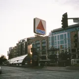 Famous Citgo sign above Kenmore Square in Boston, capturing urban life.