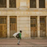 Man walking past Edificio Pedro A. Lopez in Bogotá, Colombia.