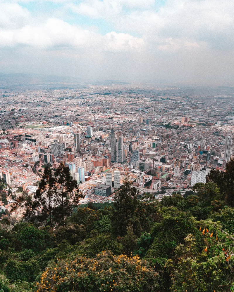Stunning aerial view of Bogotá, Colombia, showcasing its vibrant urban landscape and surrounding greenery.