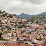 Explore the vibrant and densely packed hillside homes of Medellín, Colombia, a testament to the city's colorful culture and unique architecture.
