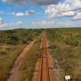 A tranquil railway track cuts through the vibrant natural landscape of Ciudad Guayana, Venezuela.